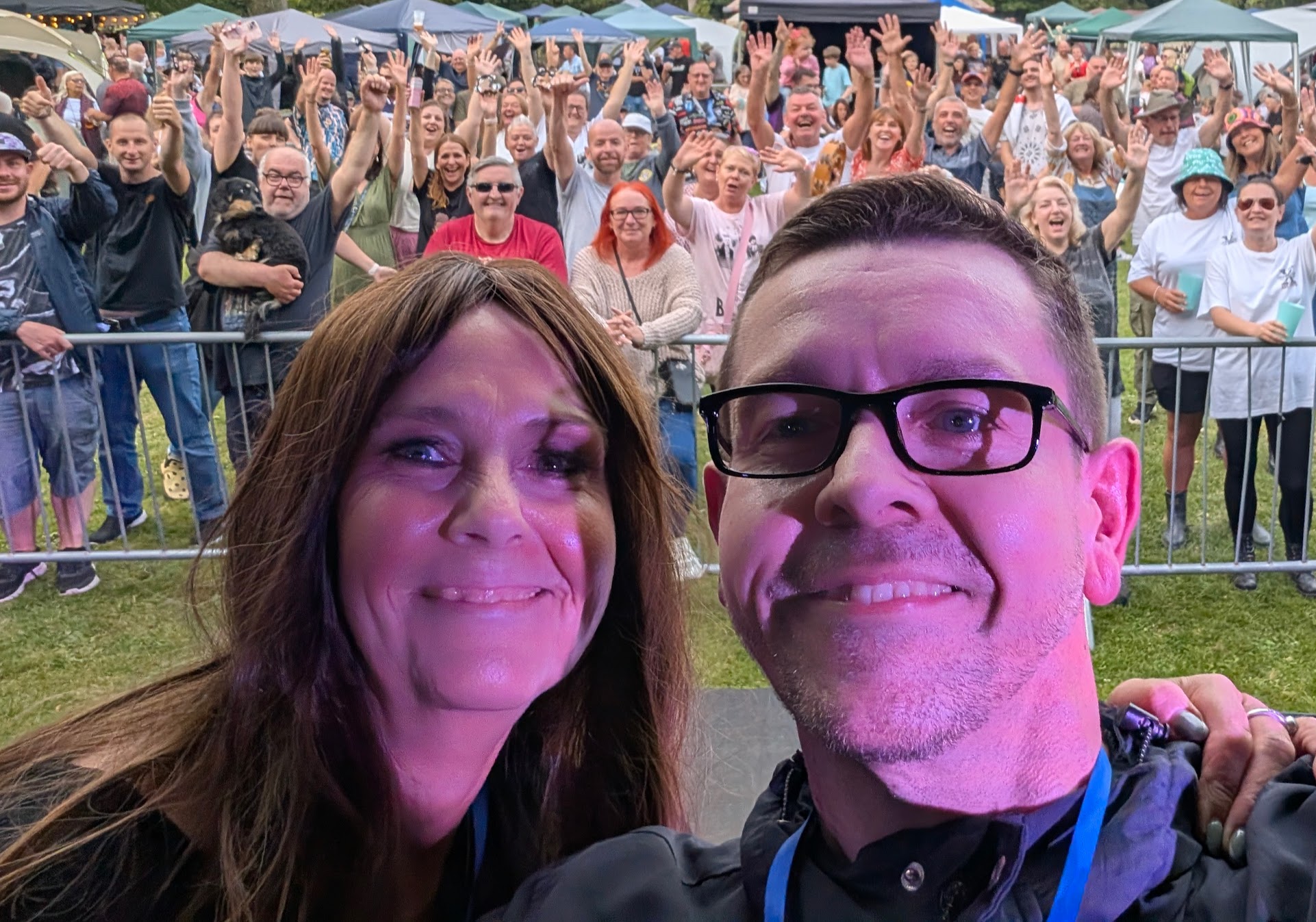 Ben and Jackie with a large crowd of festival-goers, hands raised, after a set