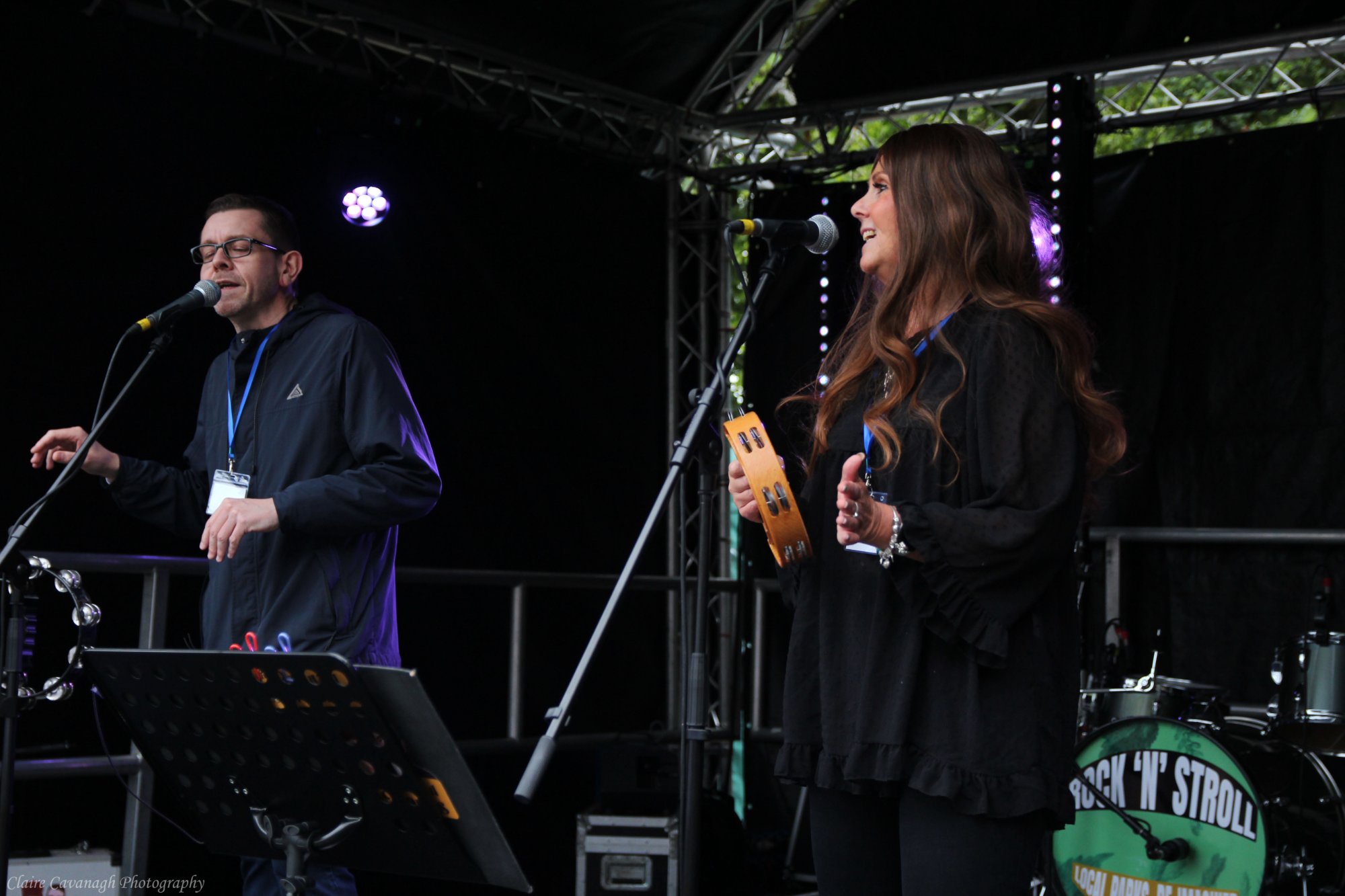 Ben and Jackie performing on stage at an outdoor festival